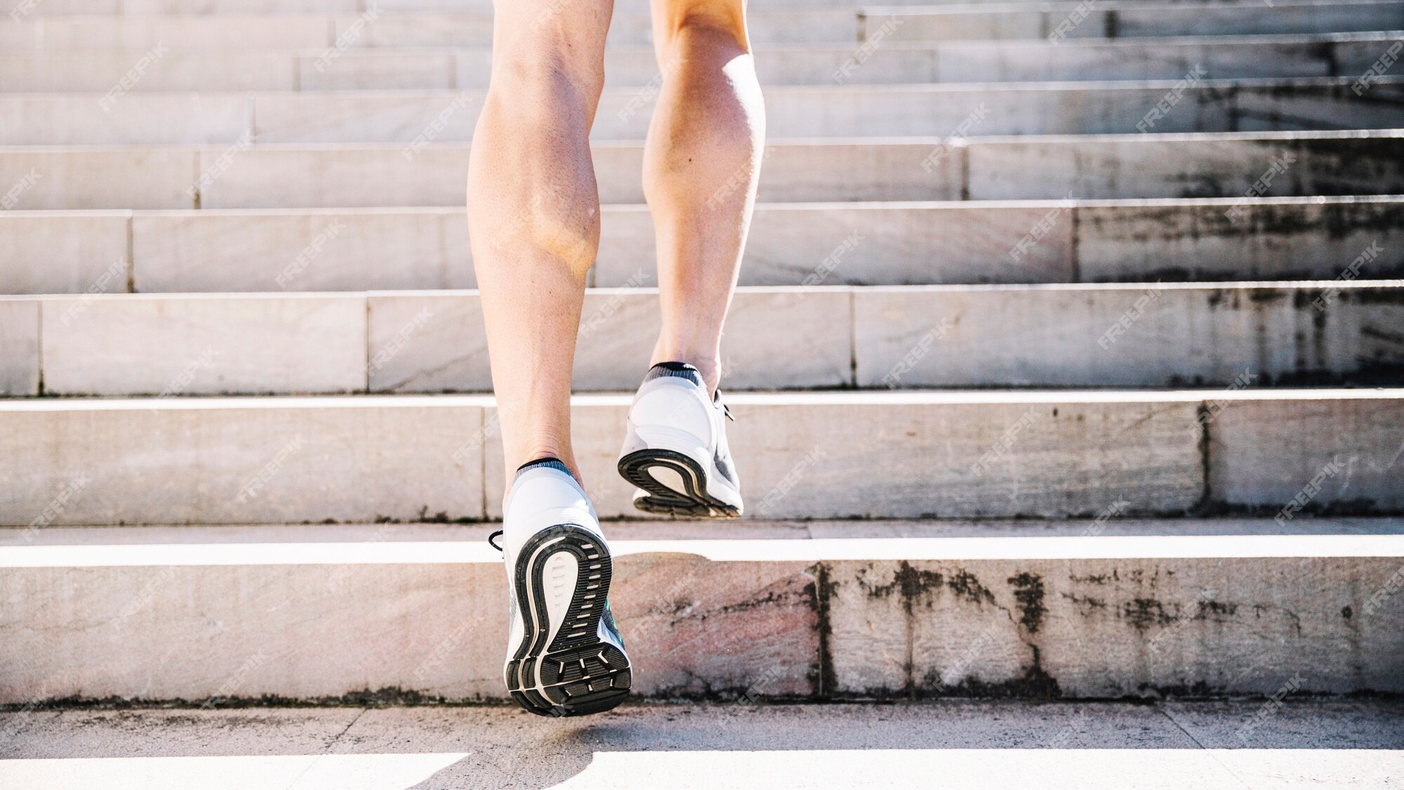 Free Photo | Crop legs in sneakers running upstairs