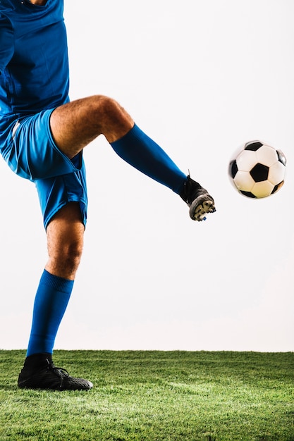 Free Photo | Crop sportsman kicking soccer ball