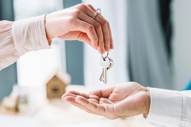 Premium Photo | Crop woman giving keys to man