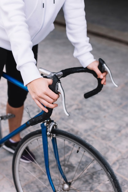 Free Photo | Crop woman holding hands on bicycle handlebar