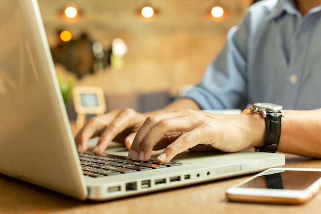 Premium Photo | Cropped image of businessman working on his laptop in a ...