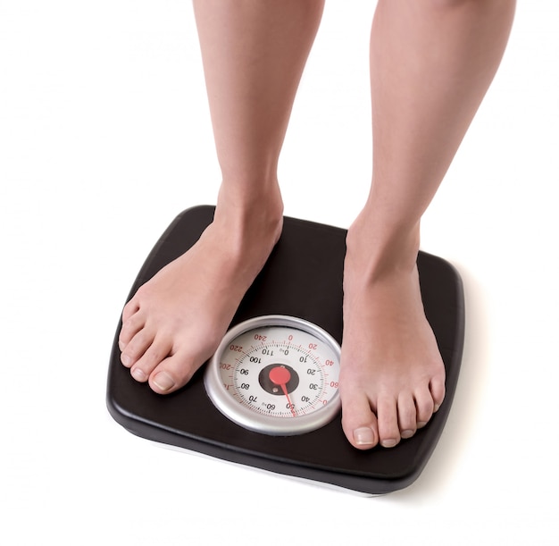 Cropped image of women feet standing on weigh scales. diet concept ...