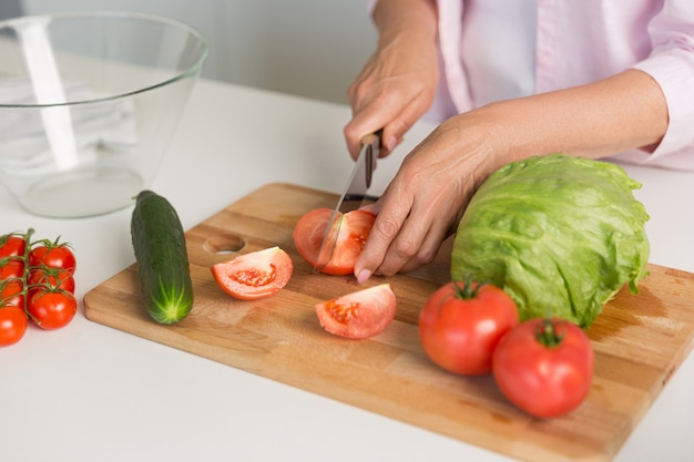 Cropped picture of mature woman cooking. Free Photo