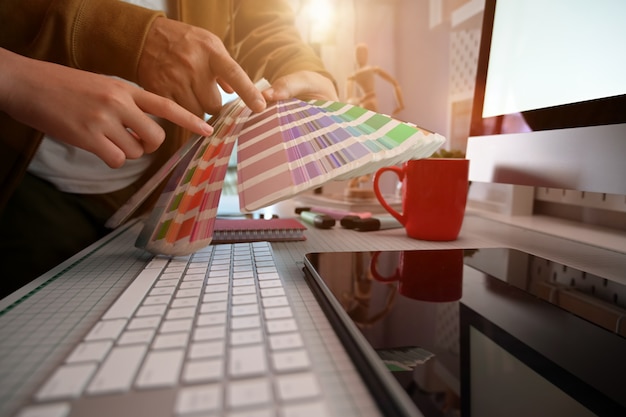 Cropped shot of creative graphic designer working on color selection and color swatches Premium Photo