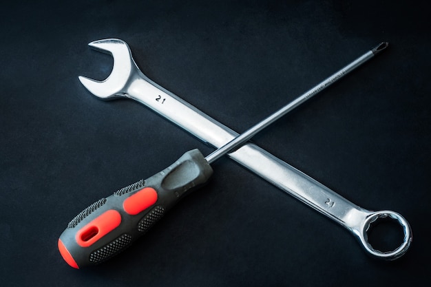 Premium Photo | Crossed spanner and screwdriver repair concept