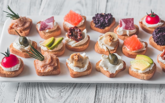 Premium Photo | Crostini with different toppings