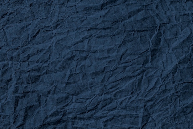 Premium Photo | Crumpled dark blue paper textured background