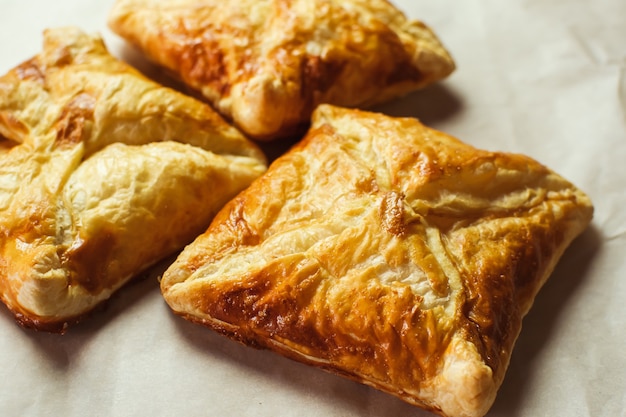 Premium Photo | Crunchy puff pastry pies, homemade baking, top view ...