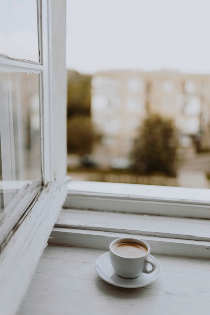 A cup of coffee by the window Photo | Free Download