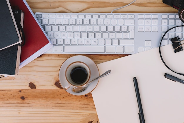 Cup of coffee near keyboard Photo | Free Download