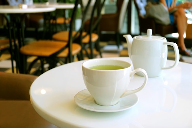 Teapot On White Round Table In A Tearoom, Round Table Promotions