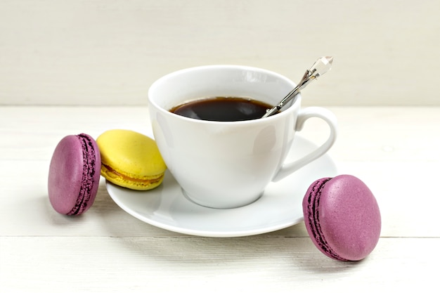 https://image.freepik.com/free-photo/cup-of-coffee-with-macaron-on-white-wooden-background-flat-lay_72679-329.jpg