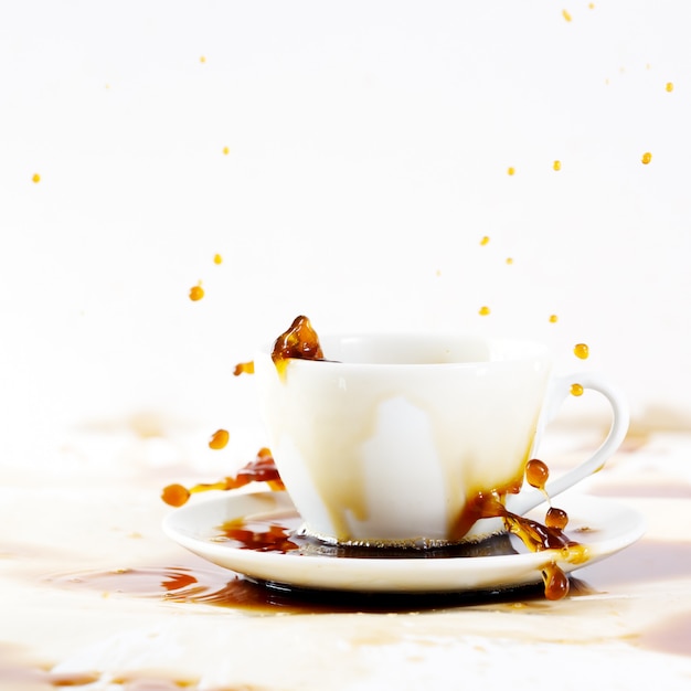Premium Photo | Cup of spilling coffee creating beautiful splash
