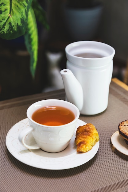 Free Photo | Cup of tea with teapot and breakfast elements