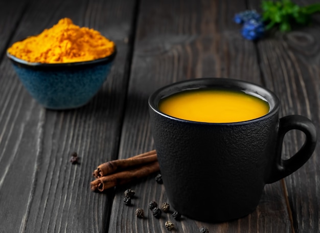 Cup with natural healthy herbal tea made from turmeric, honey and spices Free Photo