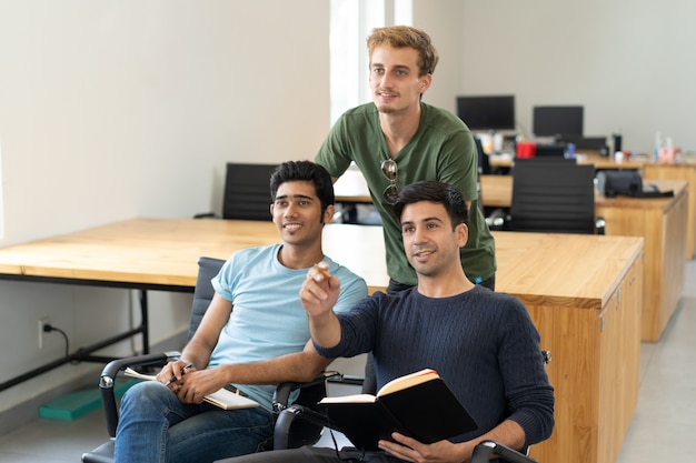 Curious students watching presentation and discussing it Free Photo