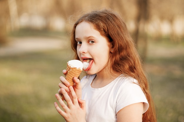 Premium Photo | Curly girl eats ice cream in the summer park