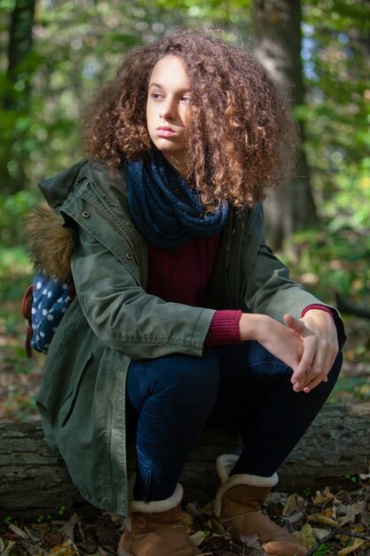 Curly Hair Teen Girl In Autumn Forest Premium Photo