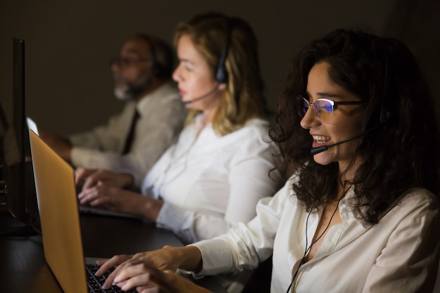 Customer service workers in dark office Free Photo