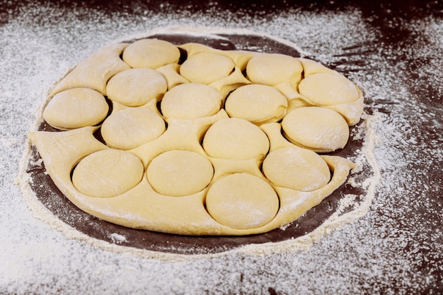 Premium Photo | Cut out dough circles for making buns, dounuts