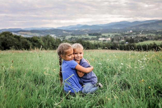 premium-photo-cute-7-8-years-girl-hugging-her-smaller-on-the-top-of