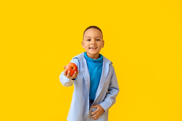 Download Premium Photo Cute African American Boy With Apple On Color Background