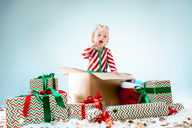 https://image.freepik.com/free-photo/cute-baby-girl-sitting-box-christmas-background-holiday-celebration-kid-concept_155003-20377.jpg
