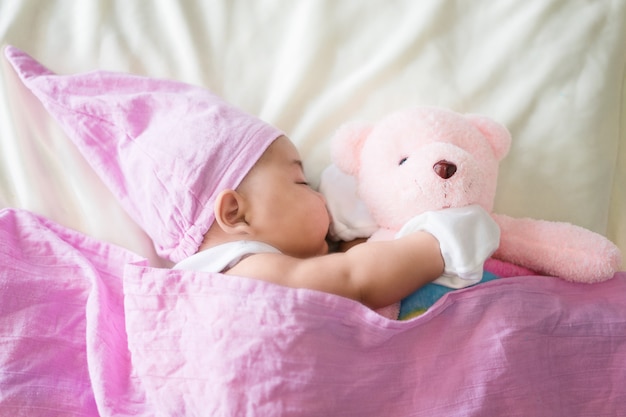 cute baby sleeping with teddy