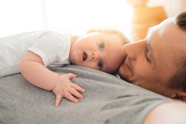 Free Photo | Cute baby lying on father