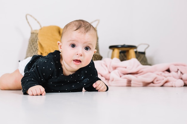 Cute baby lying on floor Photo | Free Download