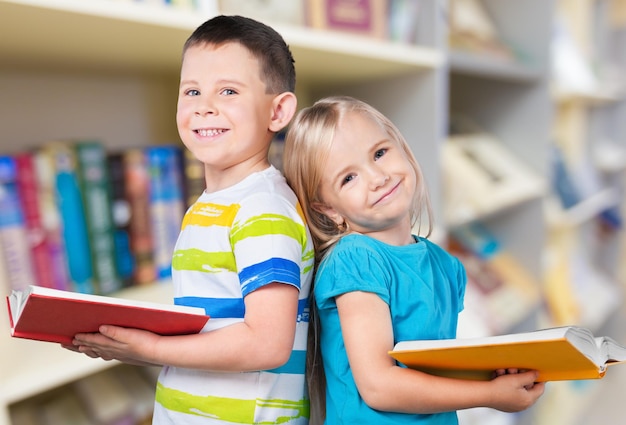 Premium Photo | Cute boy and his little sister with books