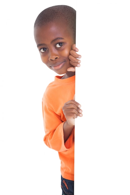 Premium Photo | Cute boy looking around corner