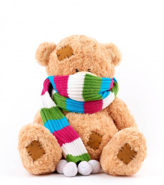 Premium Photo | Cute brown teddy bear with patches in a colored knitted ...