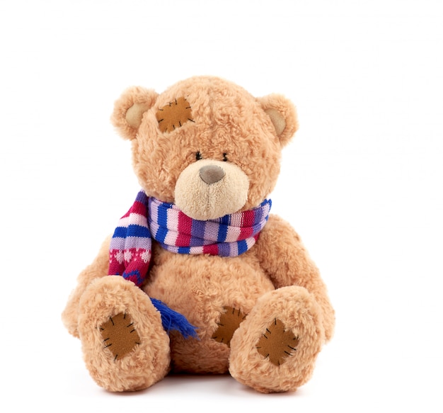 Premium Photo | Cute brown teddy bear with patches in a colored knitted ...