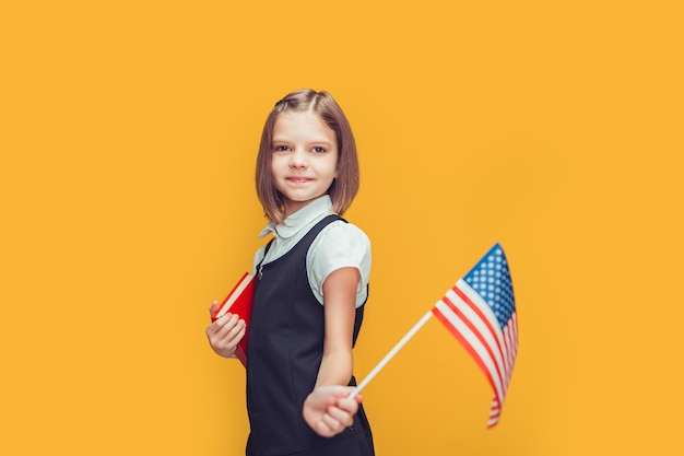 Premium Photo | Cute caucasian schoolgirl showing american flag and ...