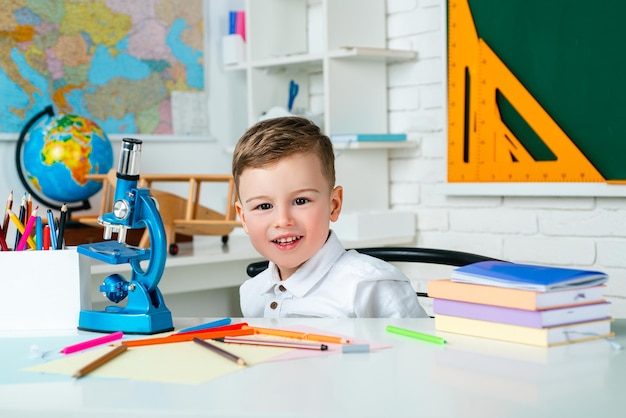 Premium Photo | Cute child indoors of the class room with blackboard on ...