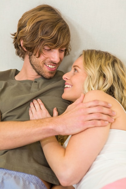 Cute Couple Cuddling On Their Bed In The Bedroom Photo