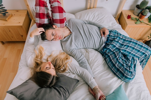 Free Photo Cute Couple Relaxing On Bed