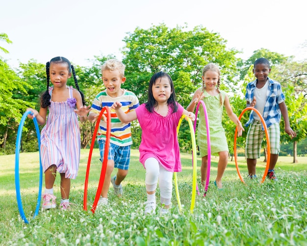 Premium Photo | Cute diverse kids playing in the park