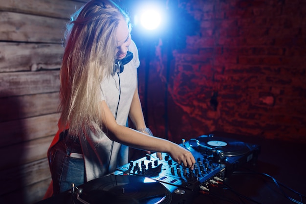 Free Photo | Cute dj woman having fun playing music at club party