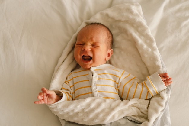 premium-photo-cute-emotional-newborn-little-baby-boy-cry-in-crib