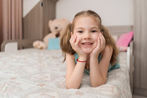 Free Photo Cute Girl Makes Funny Faces On The Bed