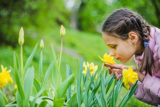 Cute girl smelling a flower | Free Photo