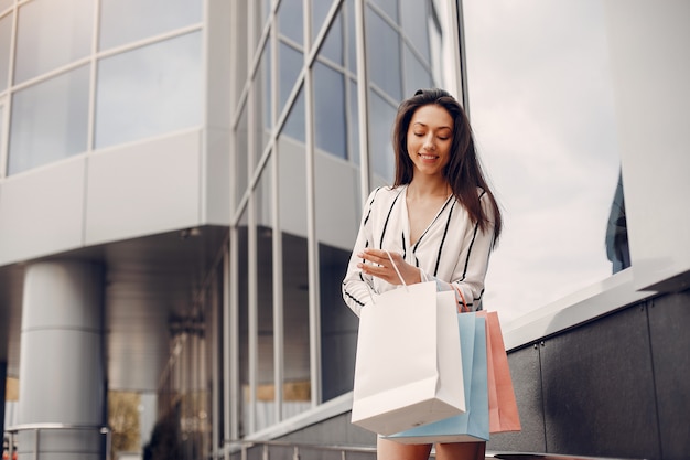 Free Photo | Cute girl with shopping bag in a city