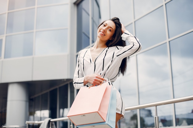 Free Photo | Cute girl with shopping bag in a city