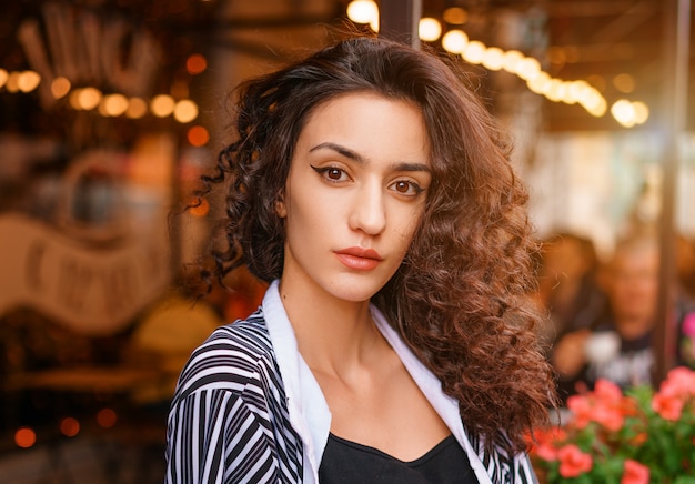 Cute Girl With Wavy Hair Portrait Of A Girl In A Cafe Premium