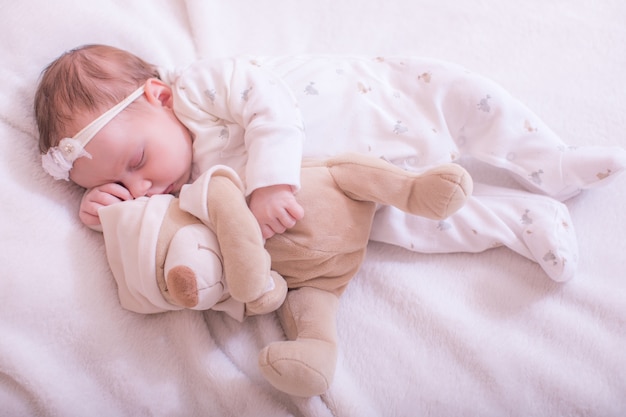 cute baby sleeping with teddy