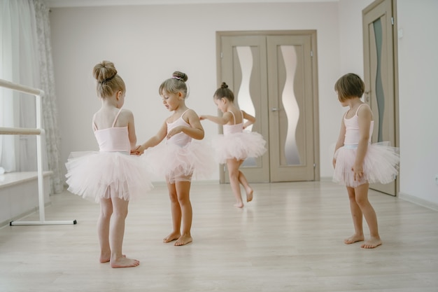ピンクのバレエ衣装のかわいい小さなバレリーナ トウシューズを履いた子供たちが部屋で踊っています 無料の写真