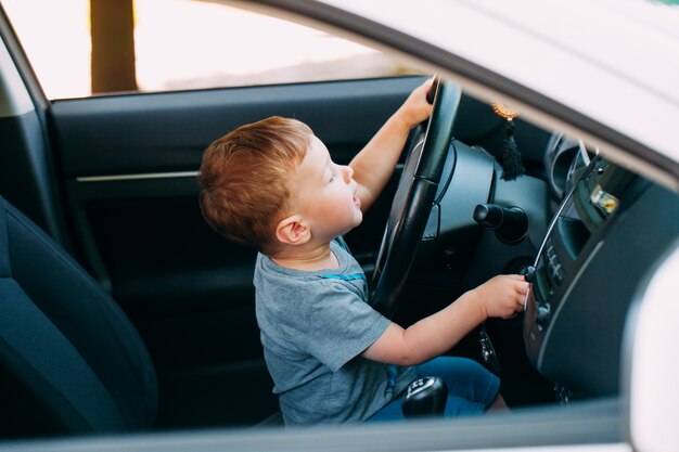 父親の車を運転してかわいい男の子 プレミアム写真