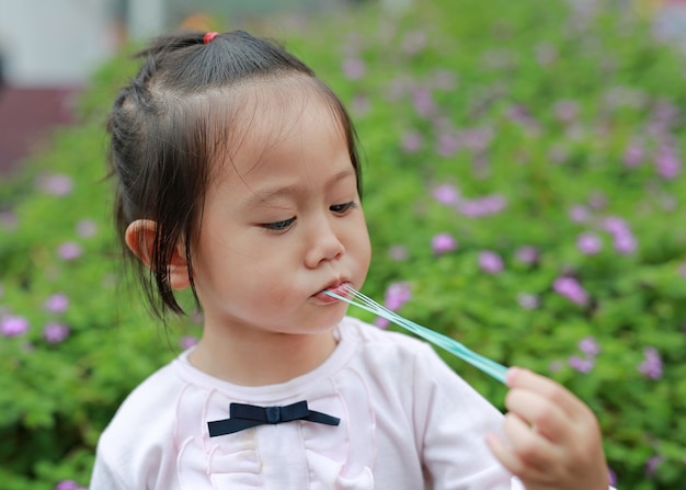 Premium Photo | Cute little girl enjoy eating bubble gum